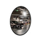 Round mirror reflecting an underground parking scene with cars.
