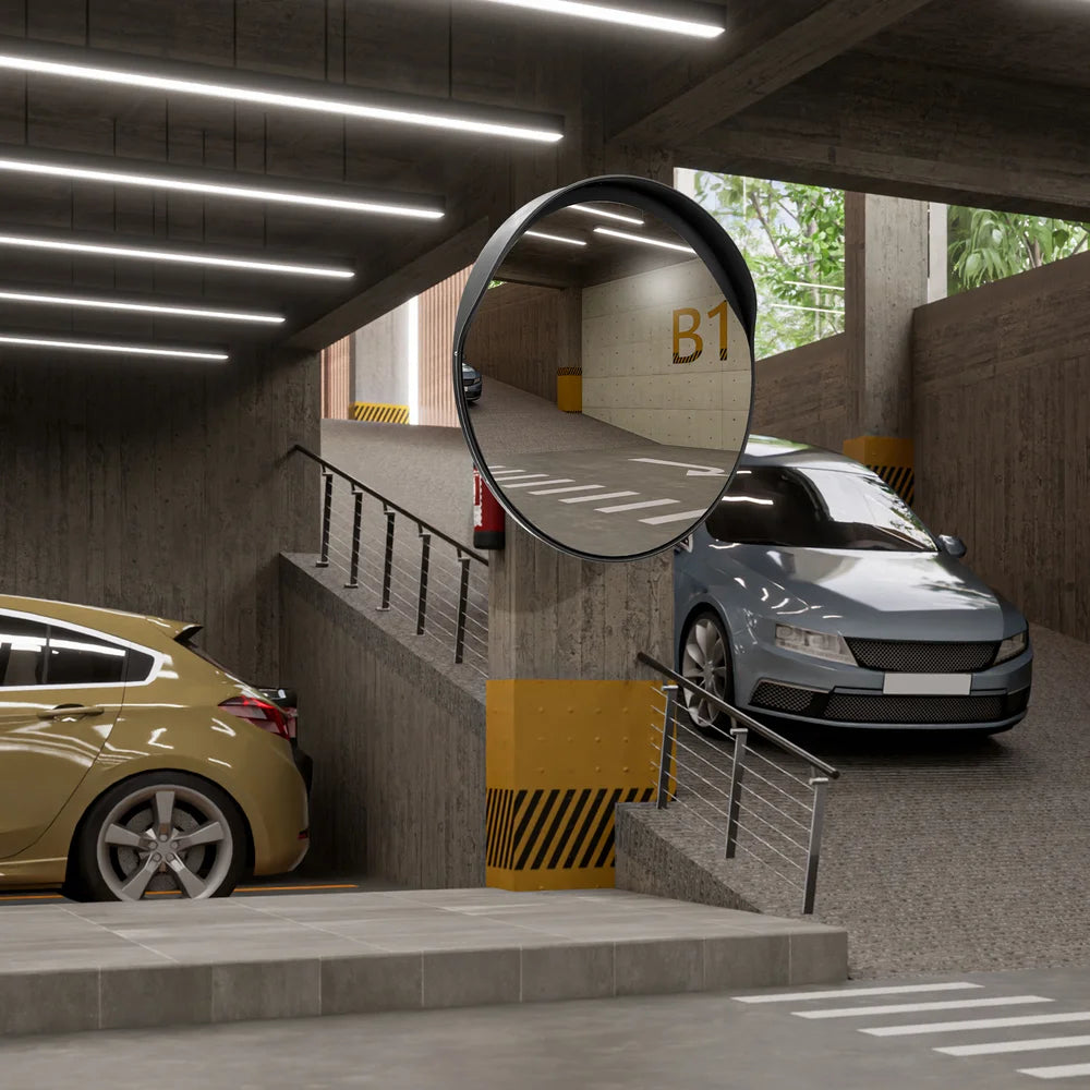 Underground parking garage with cars and a round mirror reflecting the scene.